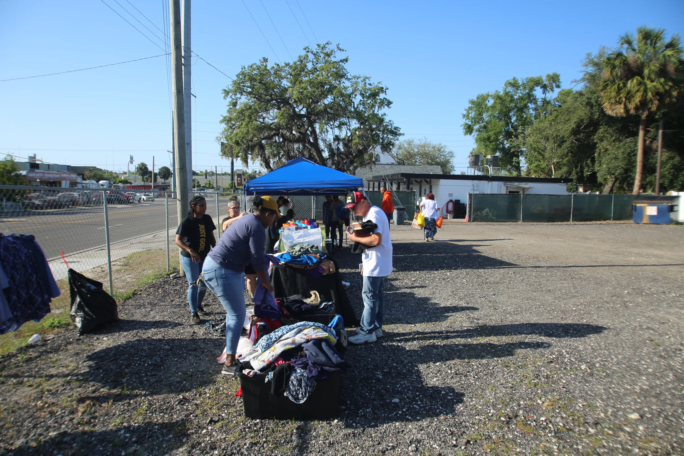 Volunteers organizing clothing at a Glory to God Foundation outreach event