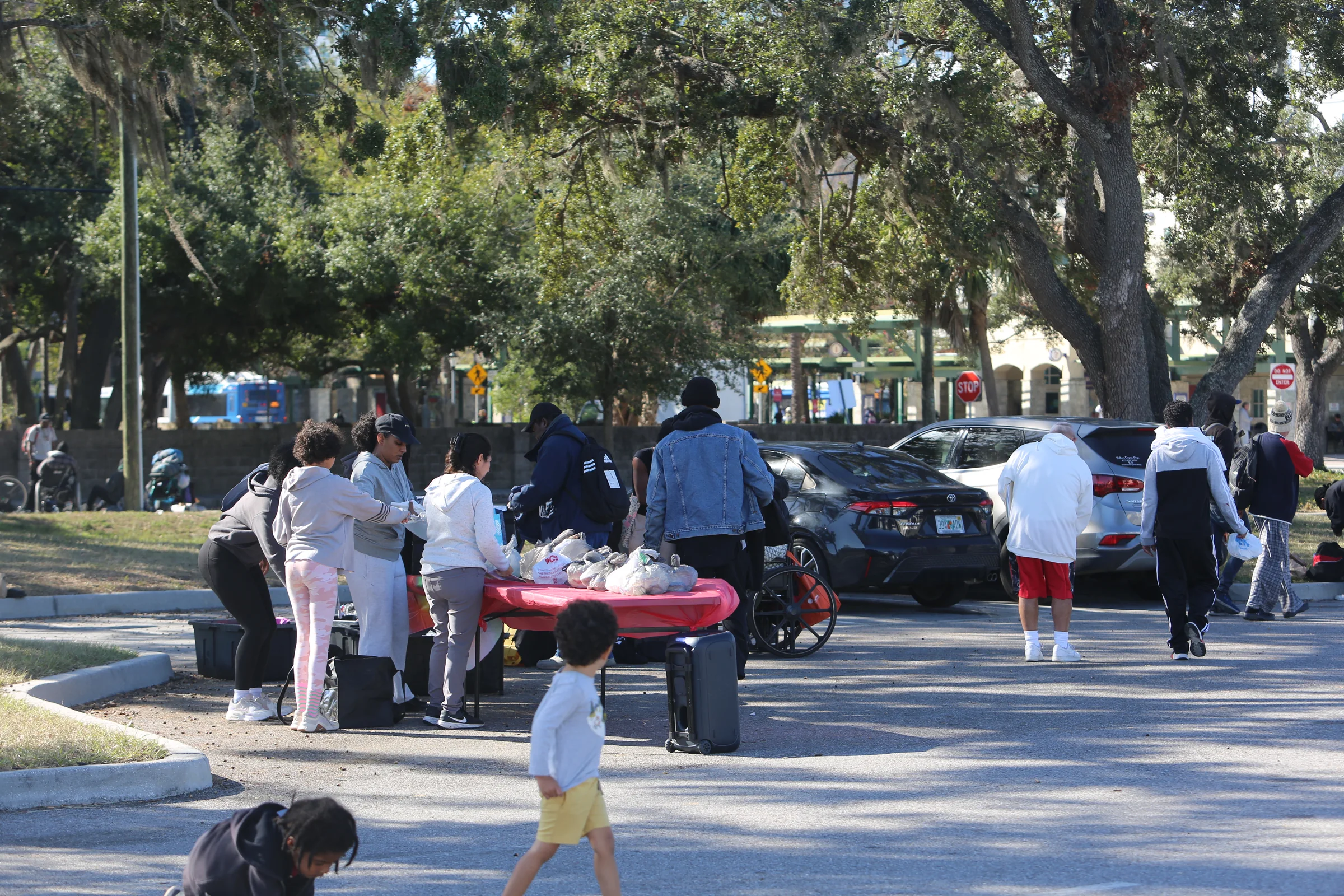 Volunteers and community members gathered for an outdoor outreach event